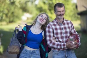 Funny village couple man and woman laughing cheerfully. photo