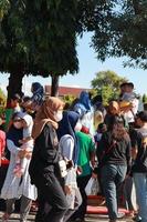 Kudus, January 2023. A snapshot of the crowds of car free day visitors crossing the zebra crossing to get to alun alun simpang 7 kudus. photo