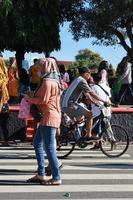 Kudus, January 2023. A snapshot of the crowds of car free day visitors crossing the zebra crossing to get to alun alun simpang 7 kudus. photo