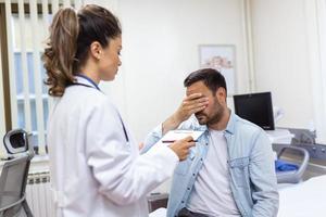 Patient receiving bad news, he is desperate and sad, Doctor support and comforting patient with sympathy. Don't worry, this medical test is not so bad photo