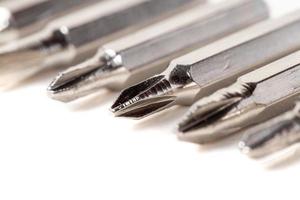 A set of different attachments for a head screwdriver with a screwdriver on a white background photo