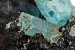 Macro mineral stone Aquamarine and black tourmaline, Schorl on a white background photo