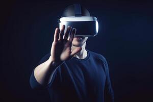 a man wearing a virtual reality headset touching the virtual object on blue tech background. photo