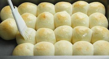 milk bun making processes, homemade bakery preparation concept, fresh dough ball with cream cooking product photo