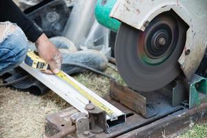 Man doing metal work using hand cutting machine tool photo