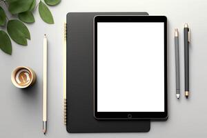 A tablet and a pen sit on top of a wooden desk. photo