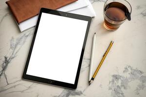 A tablet and a pen sit on top of a wooden desk. photo