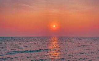 Sky sunset at beach scenery, Whether it's the warm hues of a sunrise or sunset, shimmering reflection of the sun on the clouds, the sky and clouds have the power to inspire feelings of awe and wonder photo