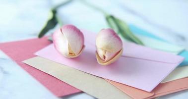 Colorful envelope and tulip flower on table video