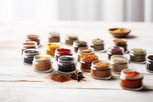 Several different spices in a small glass cans. . photo