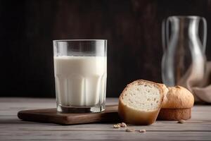 Glass of milk and white bread near. l. photo