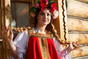 Russian girl in national dress with braids. Beautiful Slav. photo