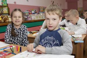 Elementary children with pencils and notebooks. photo