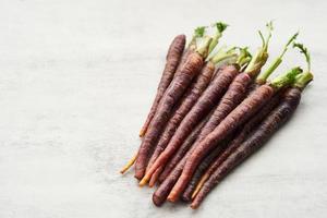 Carrot Baby Purple on grey table kitchen background photo