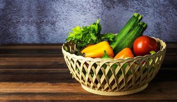 set of vegetable in basket on wooden table photo
