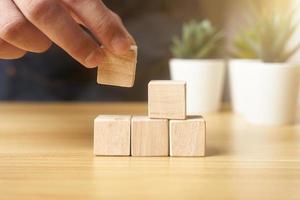 hands of businessmen, stacking wooden blocks into steps, success and business target concept, project management, company strategy development. background photo