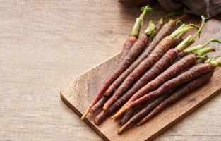 Carrot Baby Purple on wood table kitchen background photo