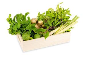 Various fresh asian herb ingredients food in wooden box isolated on white background photo