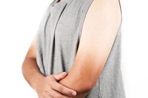 Asian man who wears grey tank top shirt with two-tone skin arm isolated on white background photo