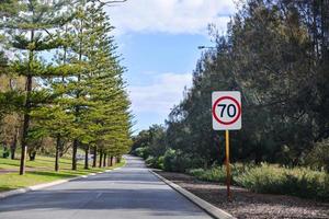 Speed 70 limit sign on a road photo