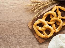 top view or flat lay group of pretzel in wood plate on wooden table background. photo