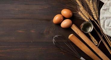 top view bakery and cooking bread pastry or cake ingredients in wooden table background with copy space. homemade photo