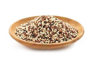 quinoa seeds in wooden bowl isolated on white background. close up quinoa seeds in wooden plate isolated on white background. quinoa seeds in spoon isolated photo