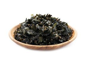 roasted nori seaweed and sesame topping in wood plate isolated on white background. nori laver seaweed crispy isolated on white background. Gim, laver, nori, isolated photo