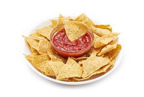 grain crisp tortilla nacho chips and sauce isolated on white background. fried tortilla nacho chips isolated on white background. baked tortilla chips isolated on white background. nacho photo