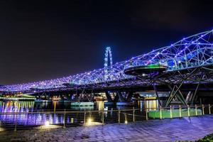 SINGAPORE - 29 October-the Helix bridge on October 29, 2014 in Singapore. The Helix bridge with Singapore Flyer in background, Singapore photo