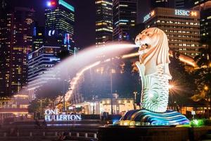 SINGAPORE-SEP 04-The Merlion fountain and downtown on Sep. 04, 2014. Merlion is an imaginary creature with a head of a lion and the body of a fish and  symbol of Singapore. photo