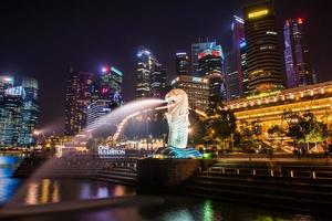 SINGAPORE-SEP 04-The Merlion fountain and downtown on Sep. 04, 2014. Merlion is an imaginary creature with a head of a lion and the body of a fish and  symbol of Singapore. photo
