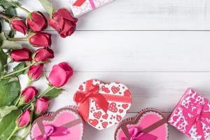 red and pink rose with gift box on old vintage white wood photo