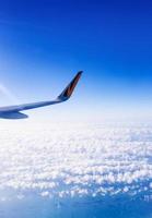 Wing of an airplane flying on the sky photo