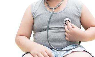 Obese asian boy check heart by stethoscope, isolated photo