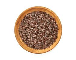 top view black mustard seed in wood plate isolated on background. a pile of black mustard seed in wood plate isolated on background. heap of black mustard seed in wood plate isolated on background photo