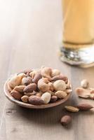 Salted mix cocktail nuts with beer and barley flower photo