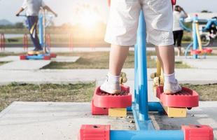 Close up of boy feet in sneakers stand on exercise machines photo