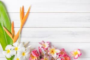 white wood texture with Heliconia and plumeria flower photo