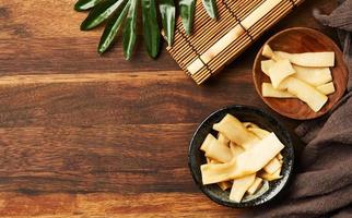 top view Ajitsuke Menma Pickled Bamboo Shoot in a wood dish on wooden table background with copy space photo