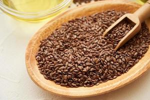 flaxseed linseed oil in wood bowl on white table background. close up flaxseed linseed oil. flaxseed linseed oil photo