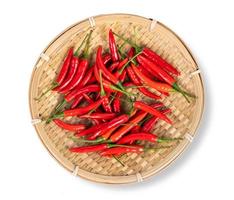 red chili peppers in wooden tray on white background photo