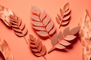 Pattern of dry orange metallic leaves on pink background. photo