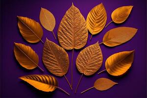 Pattern of dry orange metallic leaves on pink violet background. photo