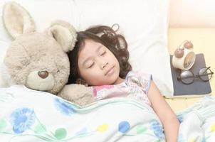 cute girl sweet dream with teddy bear on her bed photo