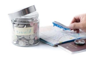 Travel budget concept. travel money savings in a glass jar. photo