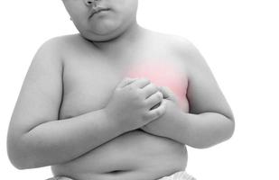 Obese fat boy is clutching him chest, acute pain possible heart attack photo