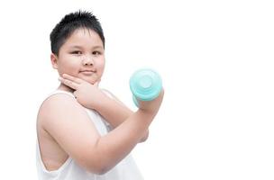 handsome obese boy is doing exercises with dumbbells photo