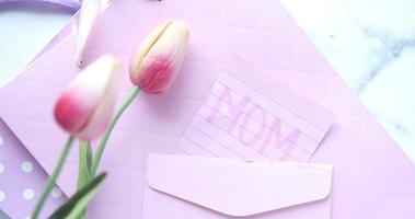 Colorful envelope and tulip flower on table video