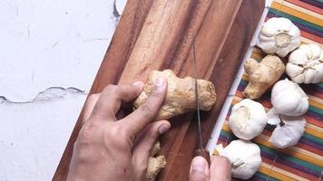 top view of turmeric root on a chopping board on table video